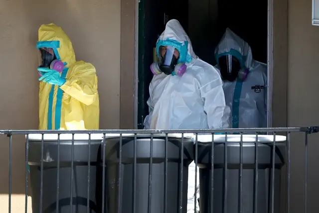 Hazmat clean-up workers sanitize the apartment of the Dallas man, Thomas Eric Duncan, who died of Ebola